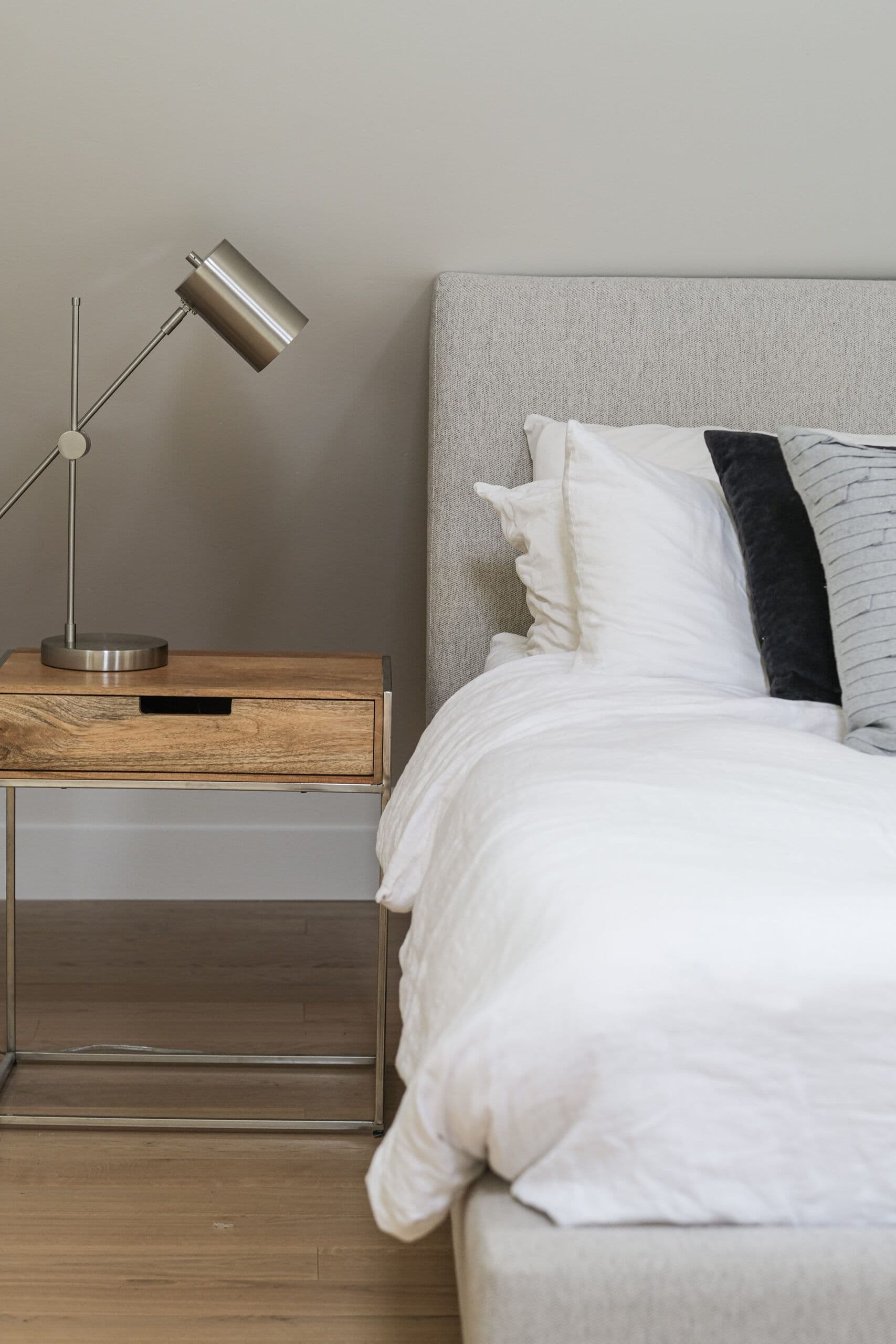 newly remodel bedroom with night stand and designer lamp